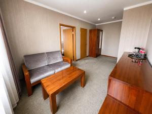 a living room with a couch and a table at Hotel Nomu in Ulaanbaatar