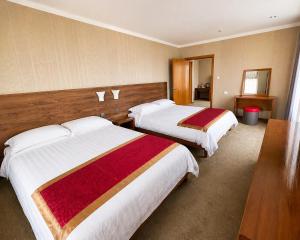 a hotel room with two beds in a room at Hotel Nomu in Ulaanbaatar