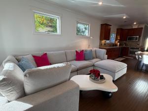 a living room with a couch and a table at Designer Garden Retreat in San Jose