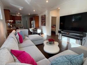 a living room with a couch and a flat screen tv at Designer Garden Retreat in San Jose