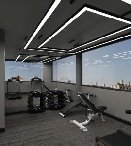 a gym with several treadmills and elliptical machines at Hôtel Le Joyau Bleu Hanoï in Hanoi