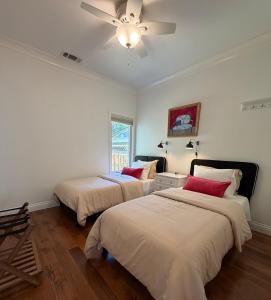 a bedroom with two beds and a ceiling fan at Designer Garden Retreat in San Jose