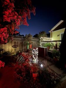 a backyard at night with a pond and lights at Designer Garden Retreat in San Jose
