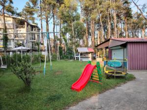 a park with a playground with slides and a slide at Giomari in Shekhvetili