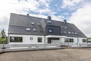 a large white building with a black roof at Apartment Maja in Winterberg
