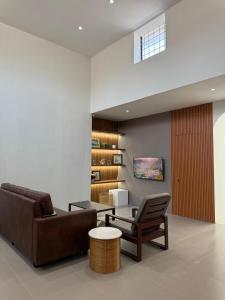 a living room with a couch and a table at Kuraya Urban Space in Surabaya