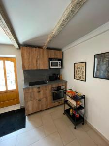 a kitchen with wooden cabinets and a microwave at L'écrin de Brévardière in Saint-Pierre-de-Chartreuse +18 photos