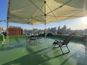 a patio with chairs and tables on a roof at BV House in Incheon