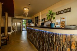 a bar in a restaurant with a stone wall at Boutique Hotel Schwarzer Baer in Lutherstadt Wittenberg