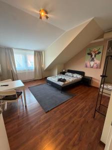 a bedroom with a bed and a table in a room at N90 Living in Karlsruhe