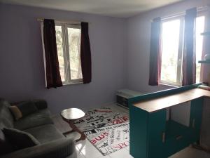 a living room with a couch and a table at Apartament Ada in Buyukada