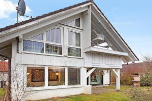 a house with large windows on the side of it at Sandra in Berghülen