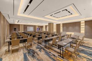 a conference room with tables and chairs and a podium at FOX Lite Hotel Majalaya in Bojong +35 photos