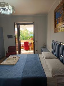a bedroom with a bed and a door to a patio at Antiche Torri Guest House in Castel Volturno