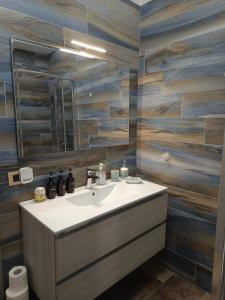 a bathroom with a sink and a mirror at Antiche Torri Guest House in Castel Volturno