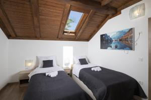 two beds in a room with a window at Mountain Escape house with indoor pool in Fužine +62 photos