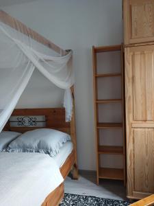 a bedroom with a bed and a book shelf at Apartament Biała Przystań in Nowy Sącz