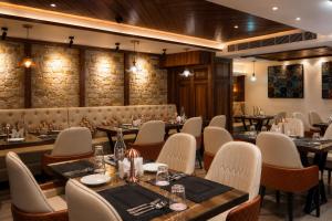 a restaurant with tables and chairs in a room at The Rosendale Srinagar in Srinagar