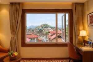a window with a view of a city at The Rosendale Srinagar in Srinagar
