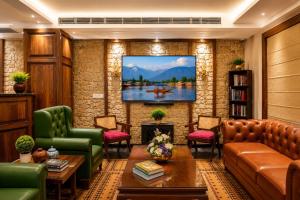 a living room with a tv on a brick wall at The Rosendale Srinagar in Srinagar