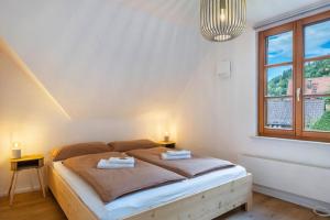 a bedroom with a bed with two towels on it at Ferienhaus Schmuckstück in Schiltach