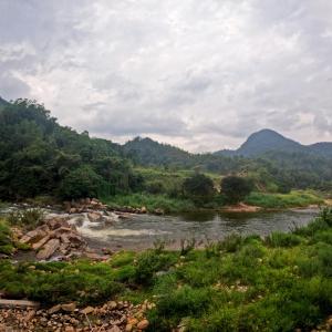 a river with mountains in the background at VRK Adventure Basecamp Sri Lanka in Kitulgala