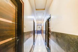 a corridor in a building with wooden floors and ceilings at Super Collection O Sindhi Camp Formerly Hotel Abhinandan Inn in Jaipur +39 photos