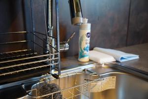 a kitchen sink with a drying rack next to a stove at Beringei house Kujukuri in Katakai +46 photos