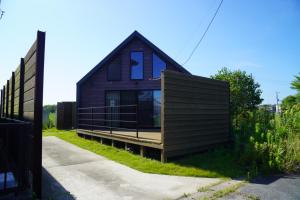 a small black house on the side of a road at Beringei house Kujukuri in Katakai