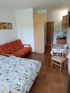 a bedroom with a bed and a table and a couch at Pod hradem Cornštejn in Oslnovice