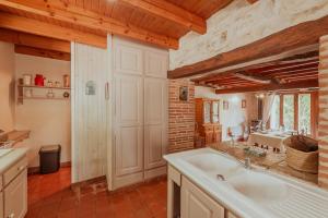a large kitchen with a sink and a counter at Les instants du lot in Trespoux-Rassiels +97 photos