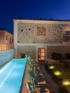 a villa with a swimming pool at night at Vento Forte - eco dimore nel borgo in Civita