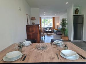 a dining room with a wooden table with plates on it at Maison de campagne - Granges sur Lot in Granges-sur-Lot