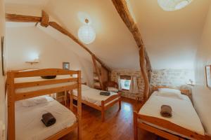 a bedroom with two bunk beds in a house at Les instants du lot in Trespoux-Rassiels