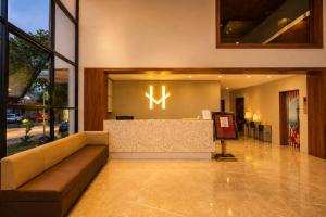 a lobby with a couch and a reception desk at Viz Park Hotel - Business Hotel & Banquet, GIDC Anand in Anand