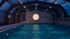a room with a pool with a ceiling with lights at IDEA Collection by GINO Hotels in Tbilisi City