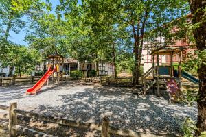 an outdoor playground with a slide and a play structure at Golf de Biscarrosse – Piscine in Biscarrosse
