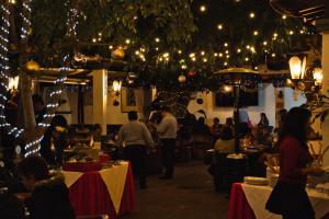 a group of people in a restaurant with tables and lights at Villa Bonita Les Terrasses in Cuernavaca +100 photos