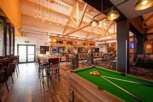 a pool table in a room with a bar at Luxury Family Caravan St Osyth Beach Clacton on Sea in Saint Osyth