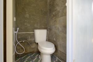 a bathroom with a toilet and a shower at Kampoeng Regang By BHATARA in Patengan
