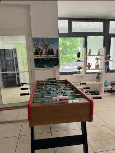 a room with a foosball table in the middle at Hôtel Le Robinson in Beaucaire
