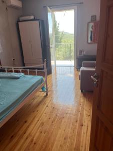 a bedroom with a bed and a door to a balcony at Templa in Himare