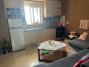 a kitchen with a refrigerator and a table in a room at Templa in Himare