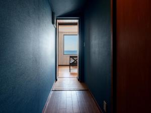 a hallway with a view of the ocean through a door at Costa Del Sol HIJI in Hiji