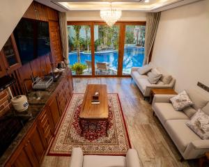 a living room with a couch and a table at MJ Villa Sanur in Sanur