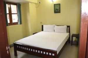 a bedroom with a bed with white sheets and a window at Luxury Villa Large Private Pool in Raichak +12 photos