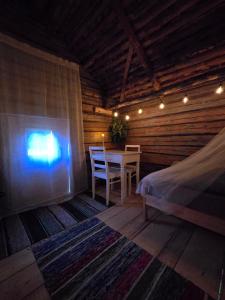 a room with a table and a chair in a cabin at Stockboden Kvarken Off Grid Cabin No Electricity or Running Water in Oravais