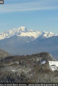 a mountain range with snow covered mountains in the distance at pas dispo moins de 5 nuits Ecogite du lac in La Thuile
