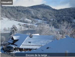 a house covered in snow with mountains in the background at pas dispo moins de 5 nuits Ecogite du lac in La Thuile
