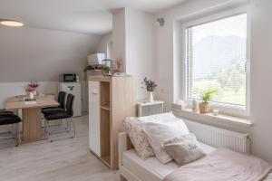 a bedroom with a bed and a desk and a window at Apartments Saint Thomas in Selca